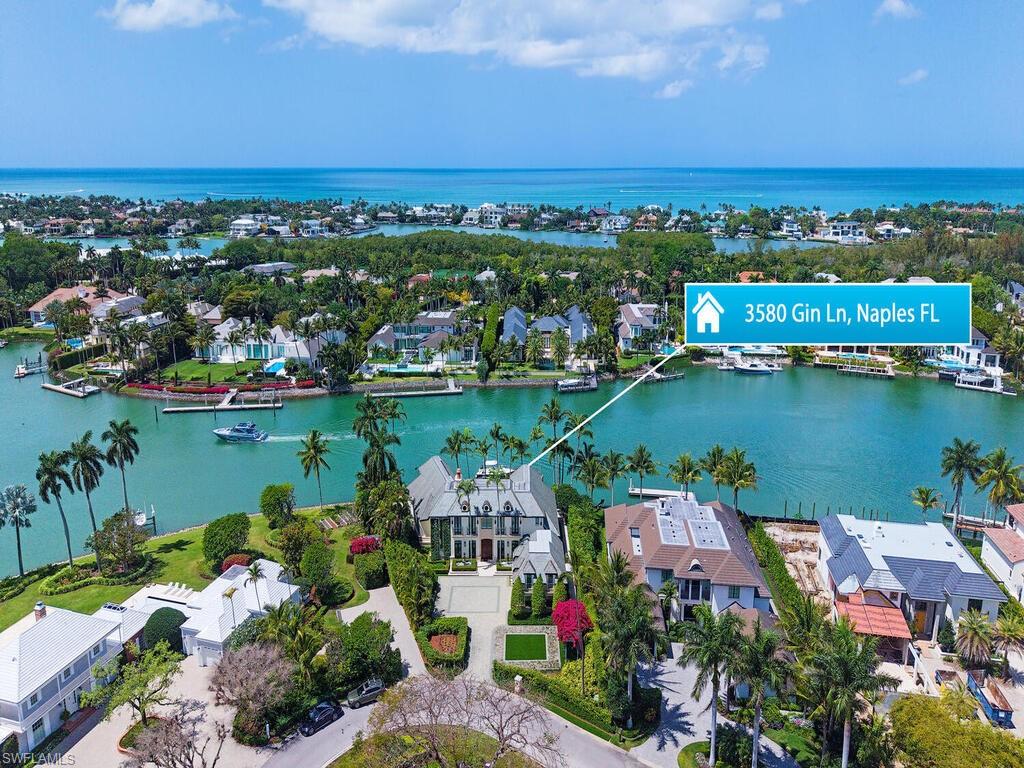 3580 Gin Lane Naples, FL 34102 - Photo 3 of 38 an aerial view of a house with a lake view
