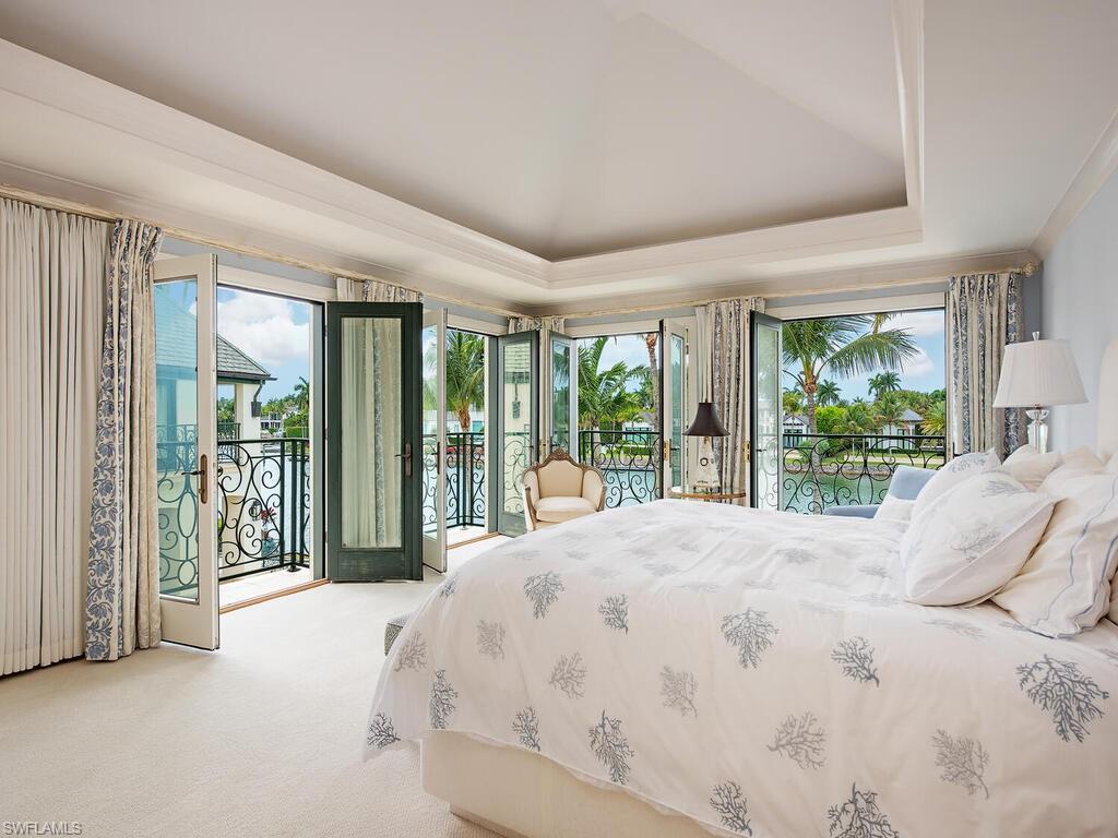 3580 Gin Lane Naples, FL 34102 - Photo 35 of 38 a large bed sitting in a bedroom next to a large window