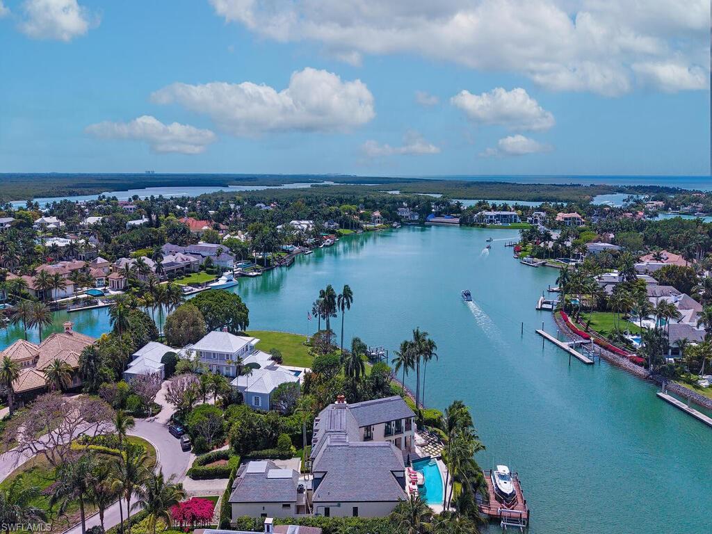 3580 Gin Lane Naples, FL 34102 - Photo 4 of 38 an aerial view of lake and residential houses with outdoor space