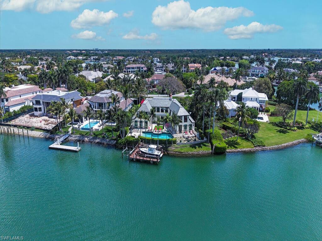 3580 Gin Lane Naples, FL 34102 - Photo 5 of 38 an aerial view of a house with a garden and lake view