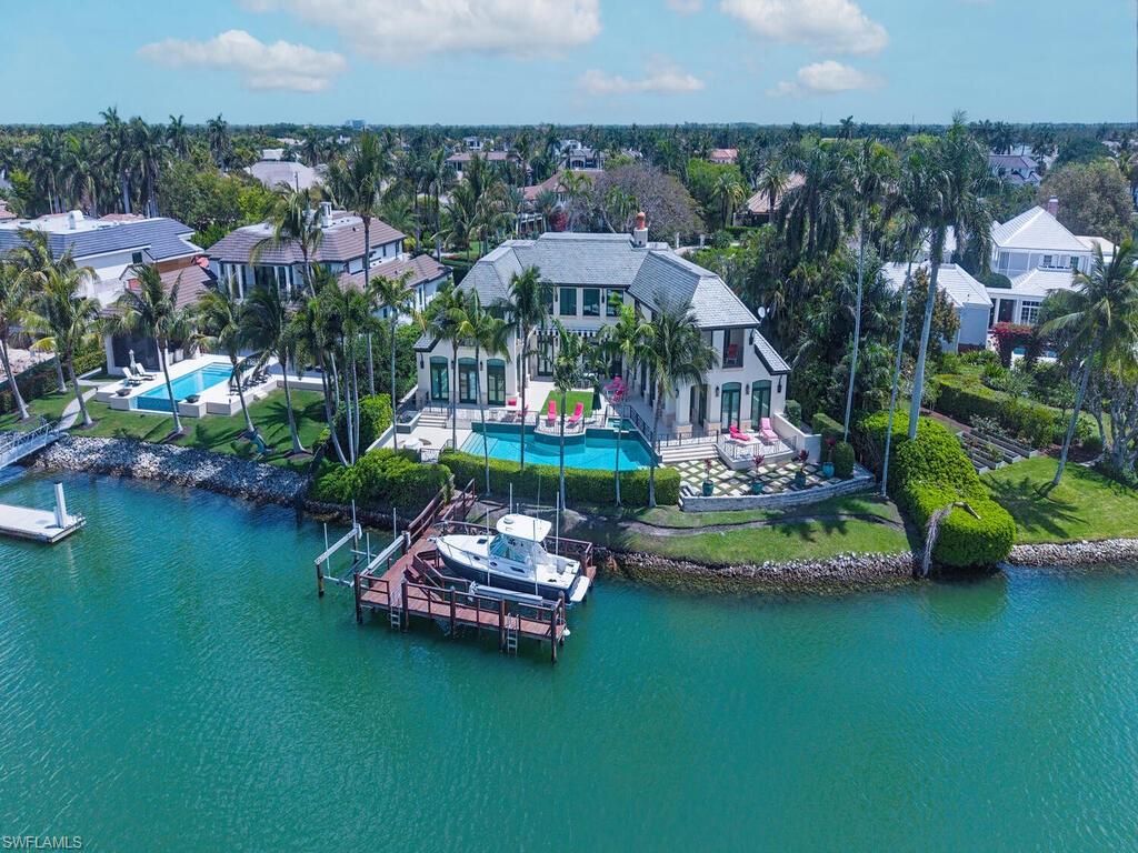 3580 Gin Lane Naples, FL 34102 - Photo 6 of 38 an aerial view of a house with a garden and lake view