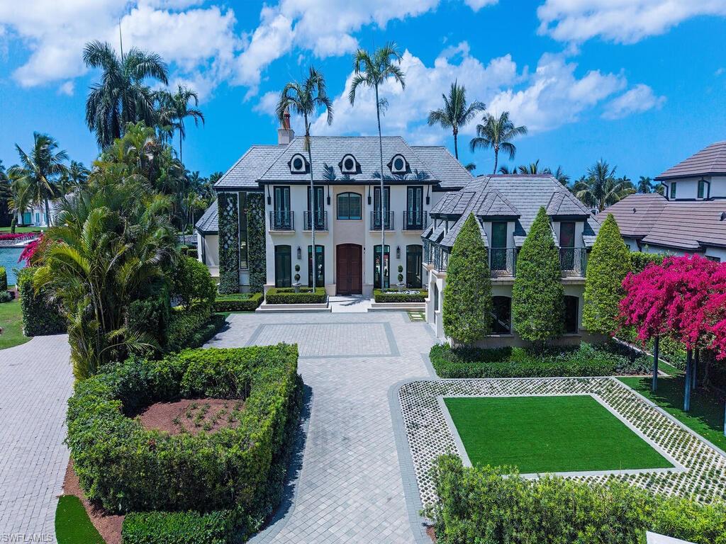 3580 Gin Lane Naples, FL 34102 - Photo 8 of 38 a front view of a house with a garden