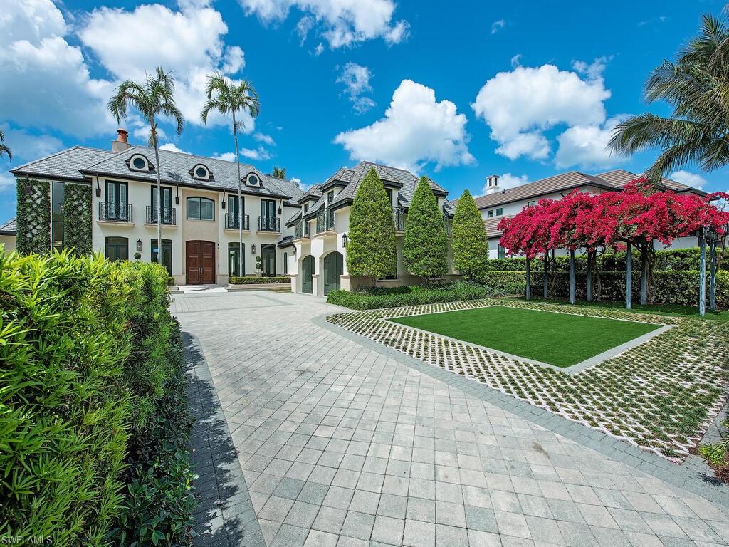3580 Gin Lane Naples, FL 34102 - Photo 10 of 38 a view of a white building with a swimming pool