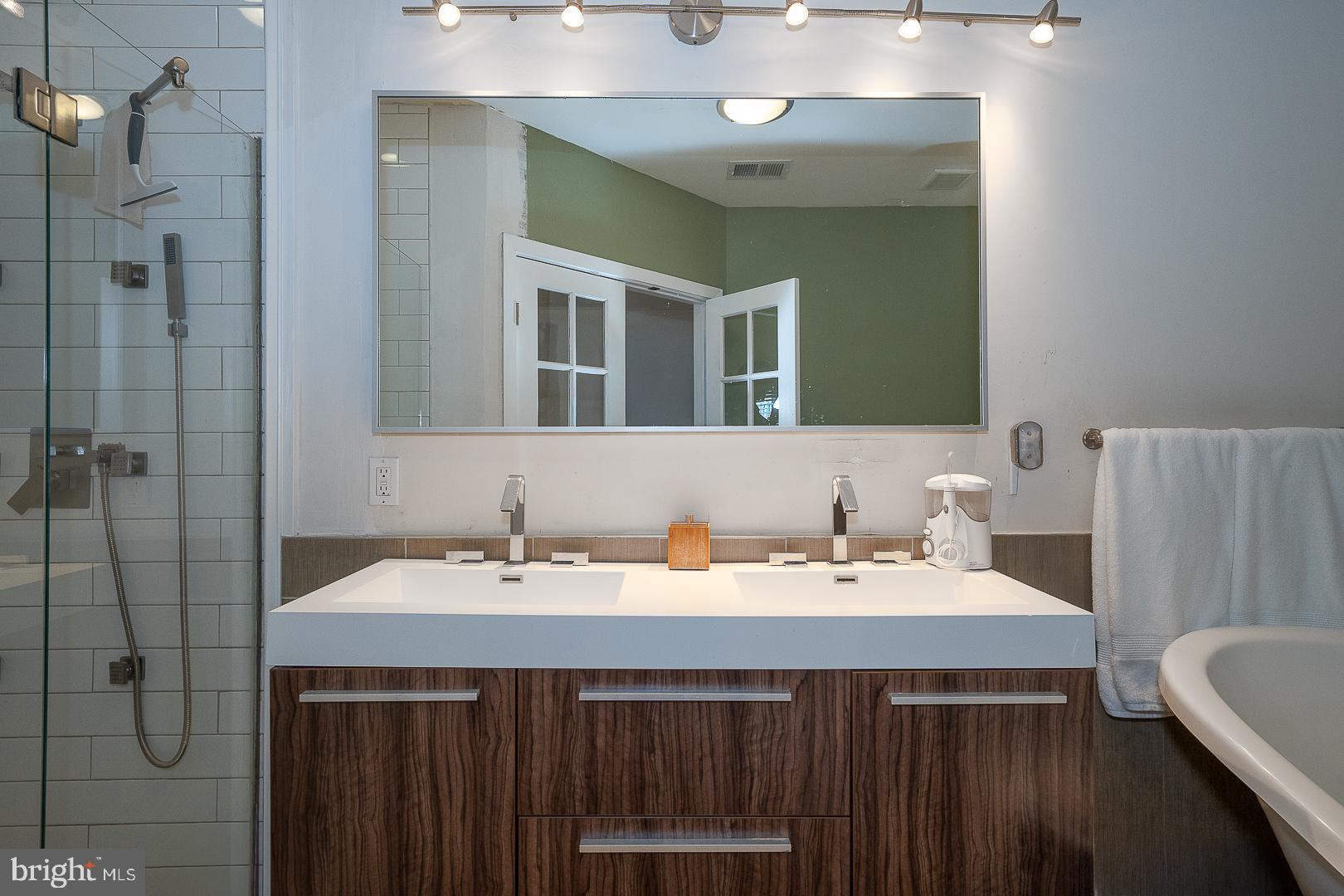 715 Shirley Street, Unit A Philadelphia, PA 19130 - Photo 20 of 24 a bathroom with a sink and a mirror
