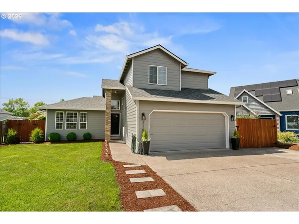 a front view of a house with a yard and garage