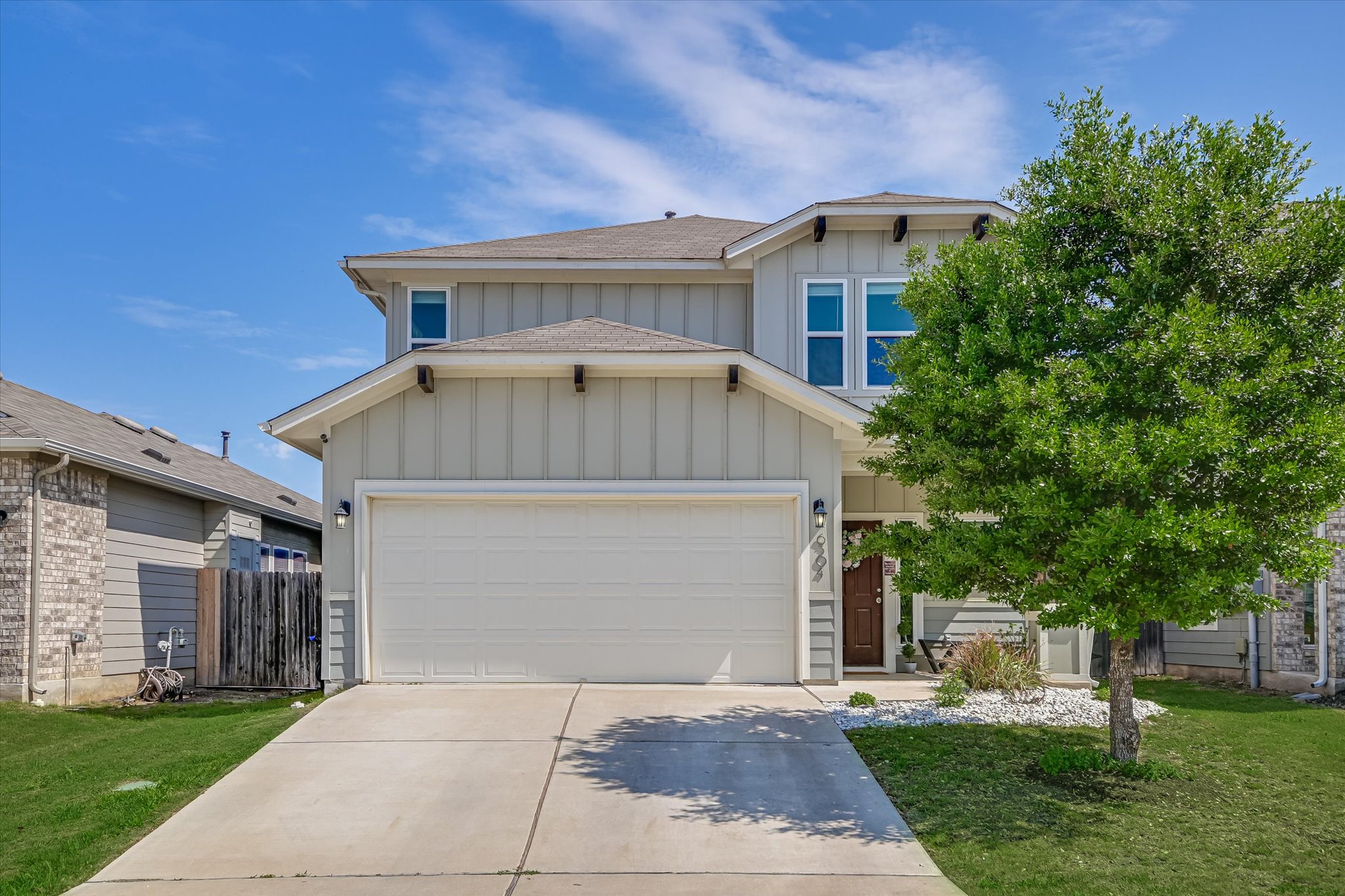 6304 Gunflint Drive Austin, TX 78747 - Photo 2 of 28 Craftsman inspired home featuring board and batten siding, driveway, a front yard, and an attached garage