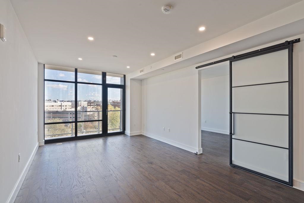 8701 Churchill Road, Unit 502 North Bergen, NJ 07047 - Photo 21 of 37 an empty room with wooden floor