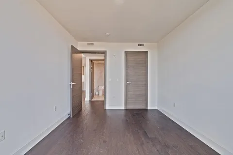 wooden floor in a hall with an empty room