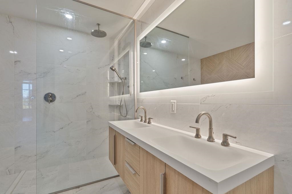 8701 Churchill Road, Unit 502 North Bergen, NJ 07047 - Photo 6 of 37 a bathroom with a sink shower and a mirror