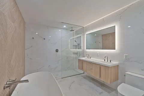 a kitchen with a sink a refrigerator and cabinets