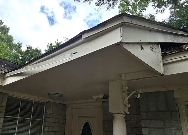 a roof deck with table and chairs