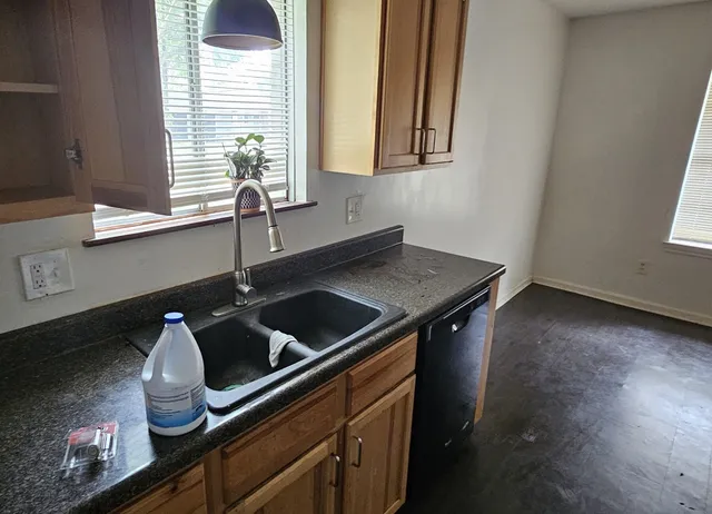 a kitchen with a sink and cabinets