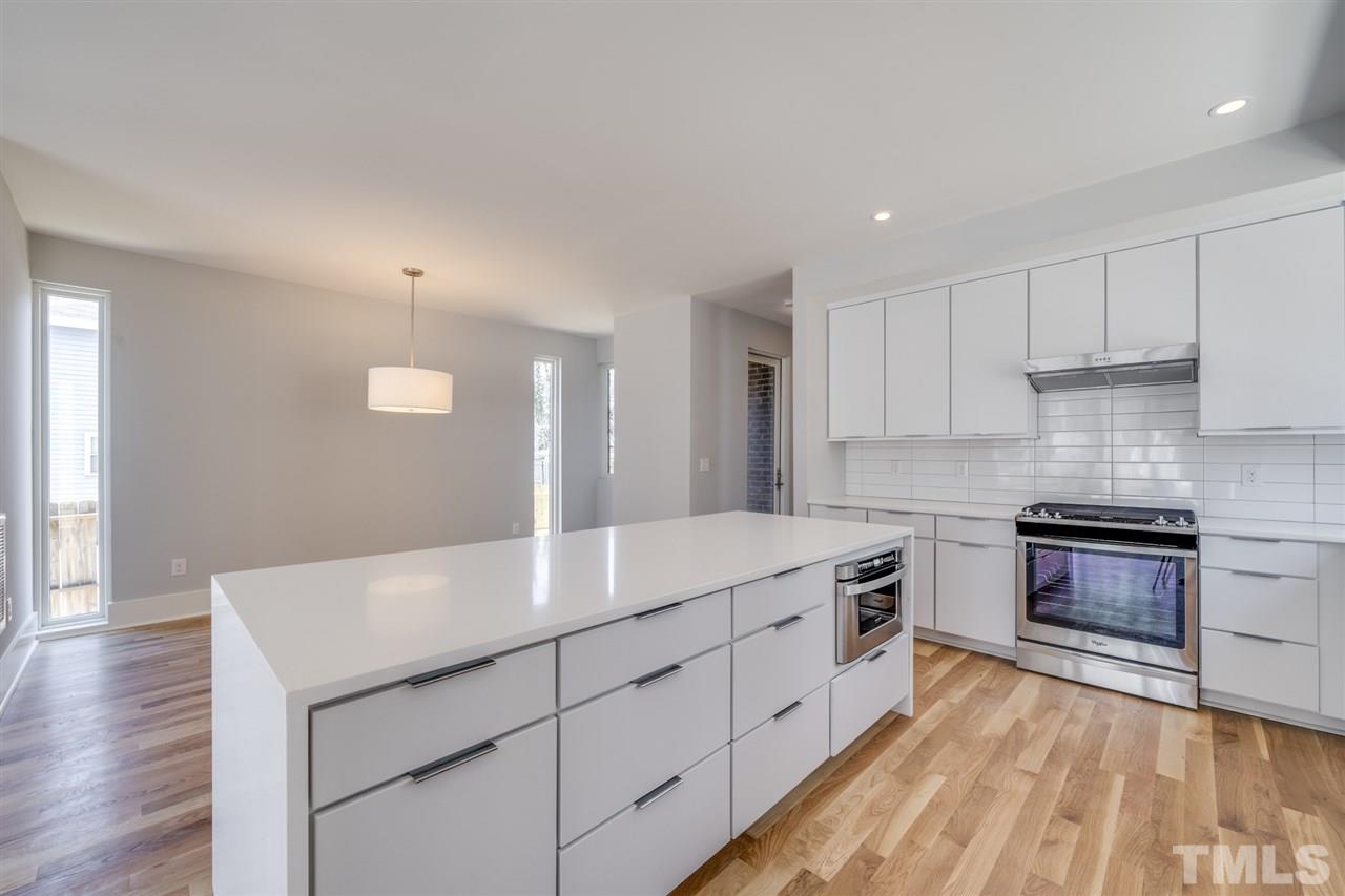 526 East Edenton Street Raleigh, NC 27601 - Photo 5 of 30 Kitchen is open to Family Room and Dining Room, with powder room located down the hallway.