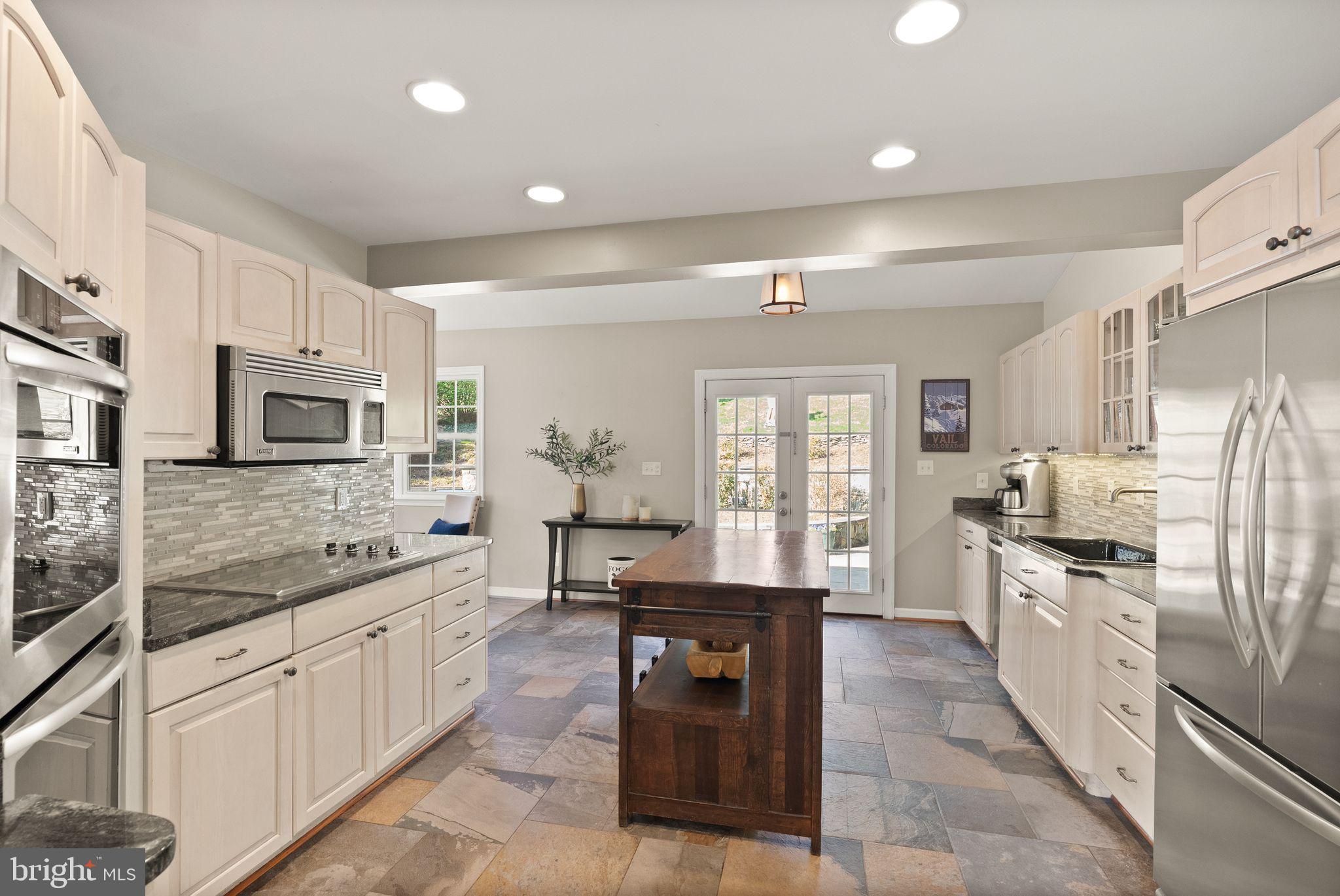 3012 Russell Road Alexandria, VA 22305 - Photo 15 of 56 a large kitchen with stainless steel appliances granite countertop a lot of counter space and a sink