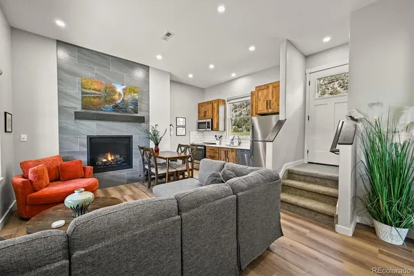 a living room with furniture and a fireplace