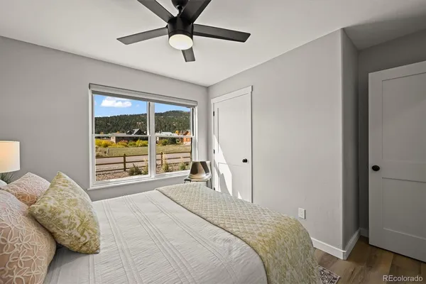 a bedroom with a large bed and a large window