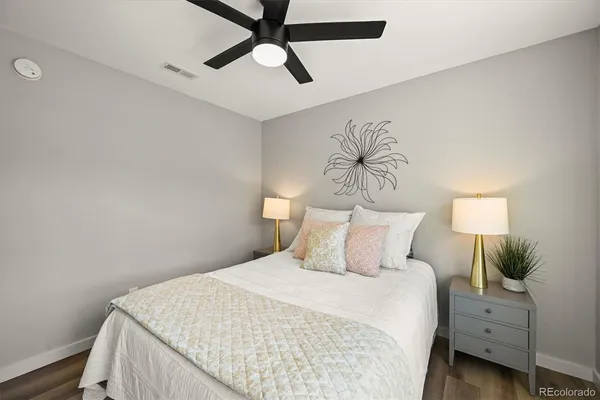 a bedroom with a bed and a chandelier