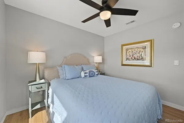 a bedroom with a bed and a lamp on table
