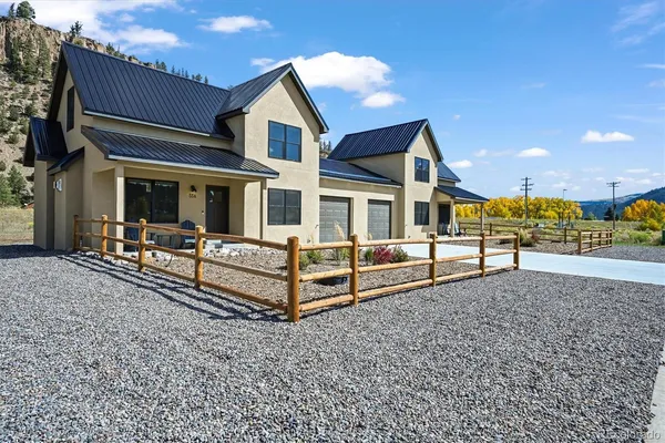 a view of a house with a wooden fence