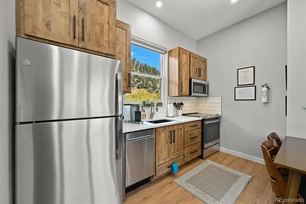 a kitchen with stainless steel appliances a refrigerator sink and cabinets