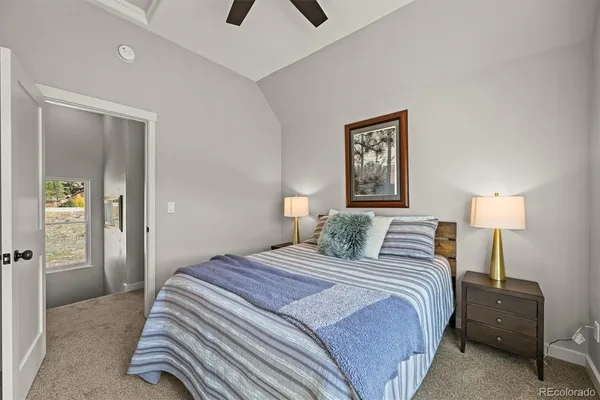 a bedroom with a bed and a lamp