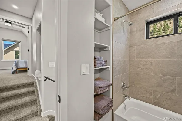 a bathroom with a tub and a shower