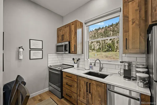 a kitchen with stainless steel appliances a sink stove and a refrigerator