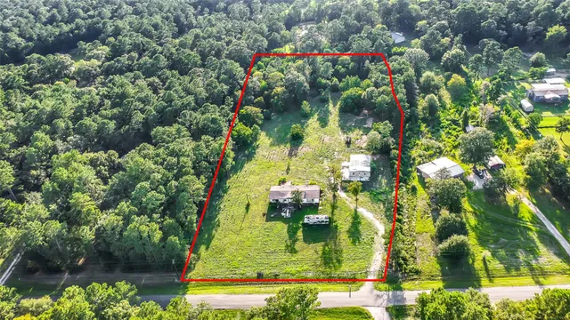 a backyard of a house with a yard and outdoor seating