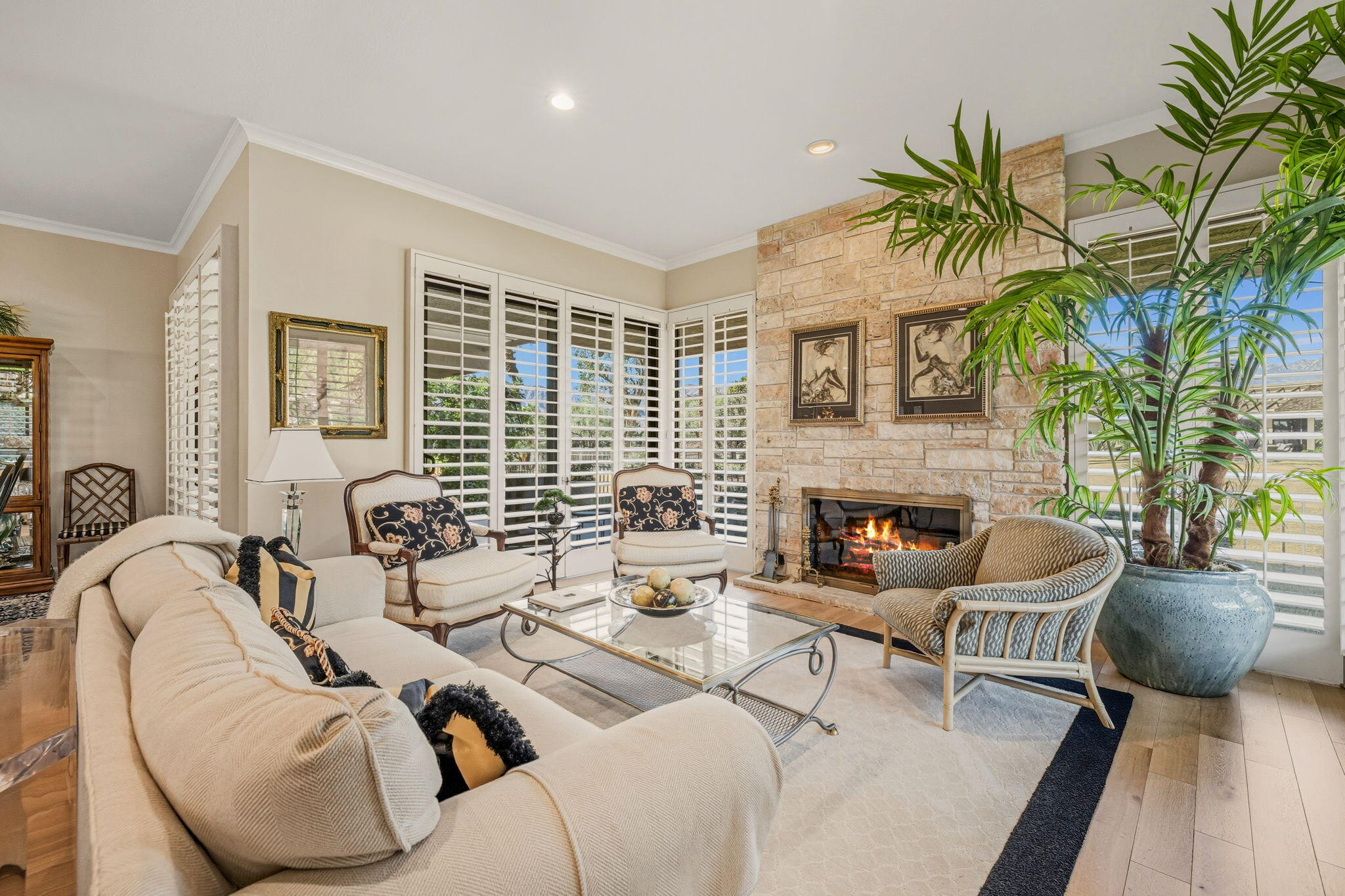 10 Whittier Court Rancho Mirage, CA 92270 - Photo 16 of 62 a living room with furniture fireplace and a large window