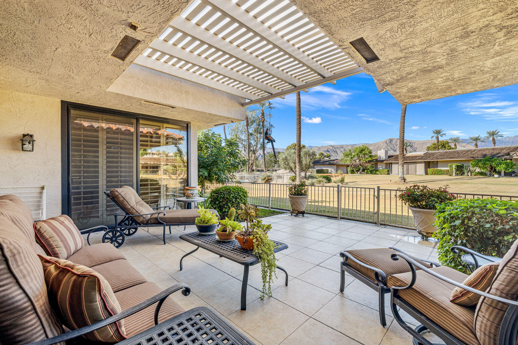 10 Whittier Court Rancho Mirage, CA 92270 - Photo 24 of 62 a living room with patio furniture and a potted plants