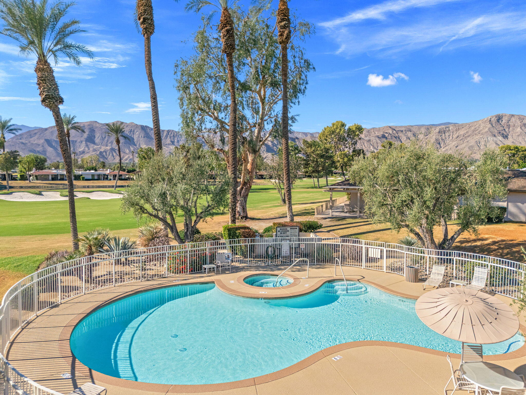10 Whittier Court Rancho Mirage, CA 92270 - Photo 27 of 62 a view of a swimming pool with a patio