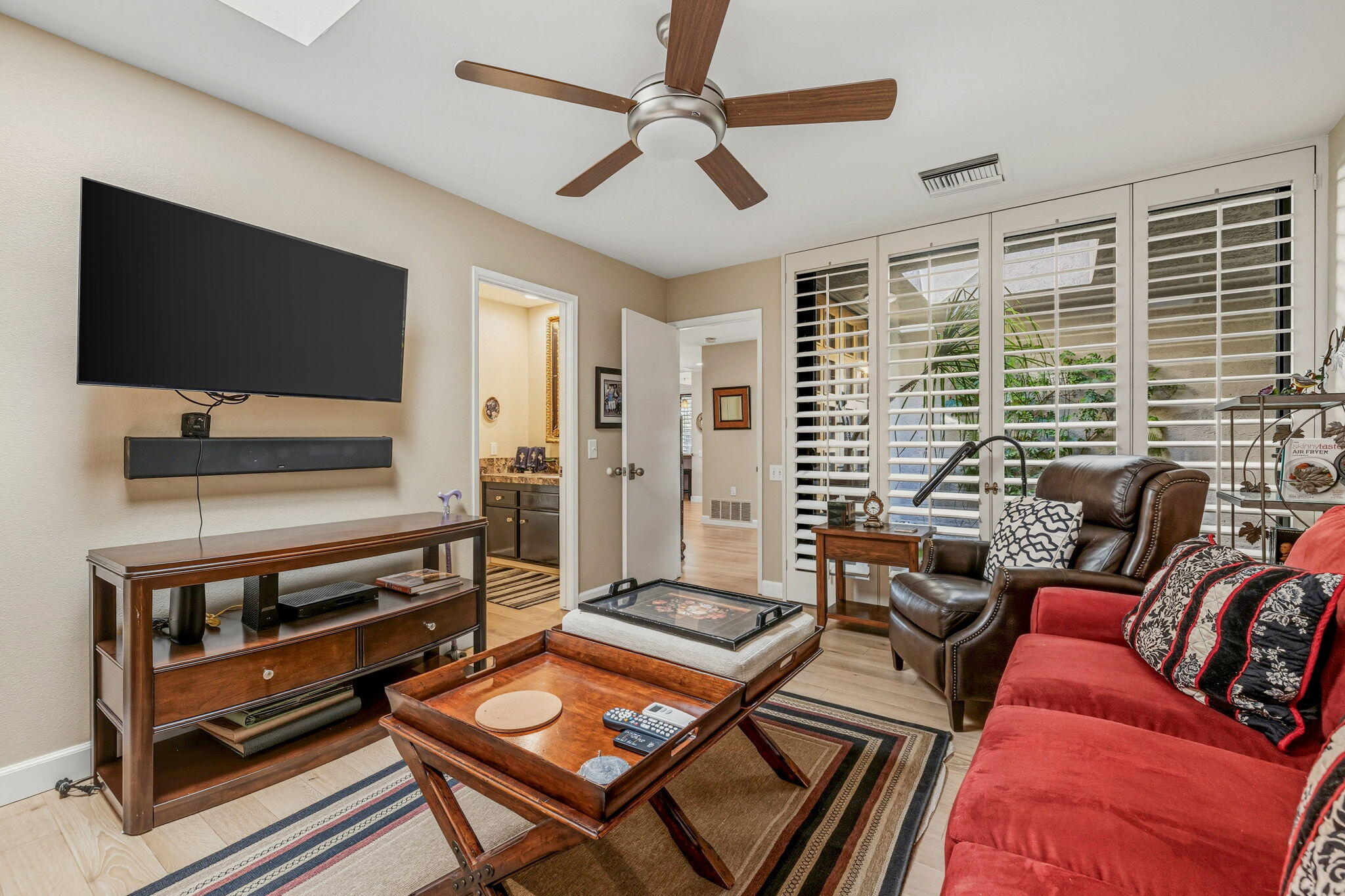 10 Whittier Court Rancho Mirage, CA 92270 - Photo 37 of 62 a living room with furniture a flat screen tv and a window
