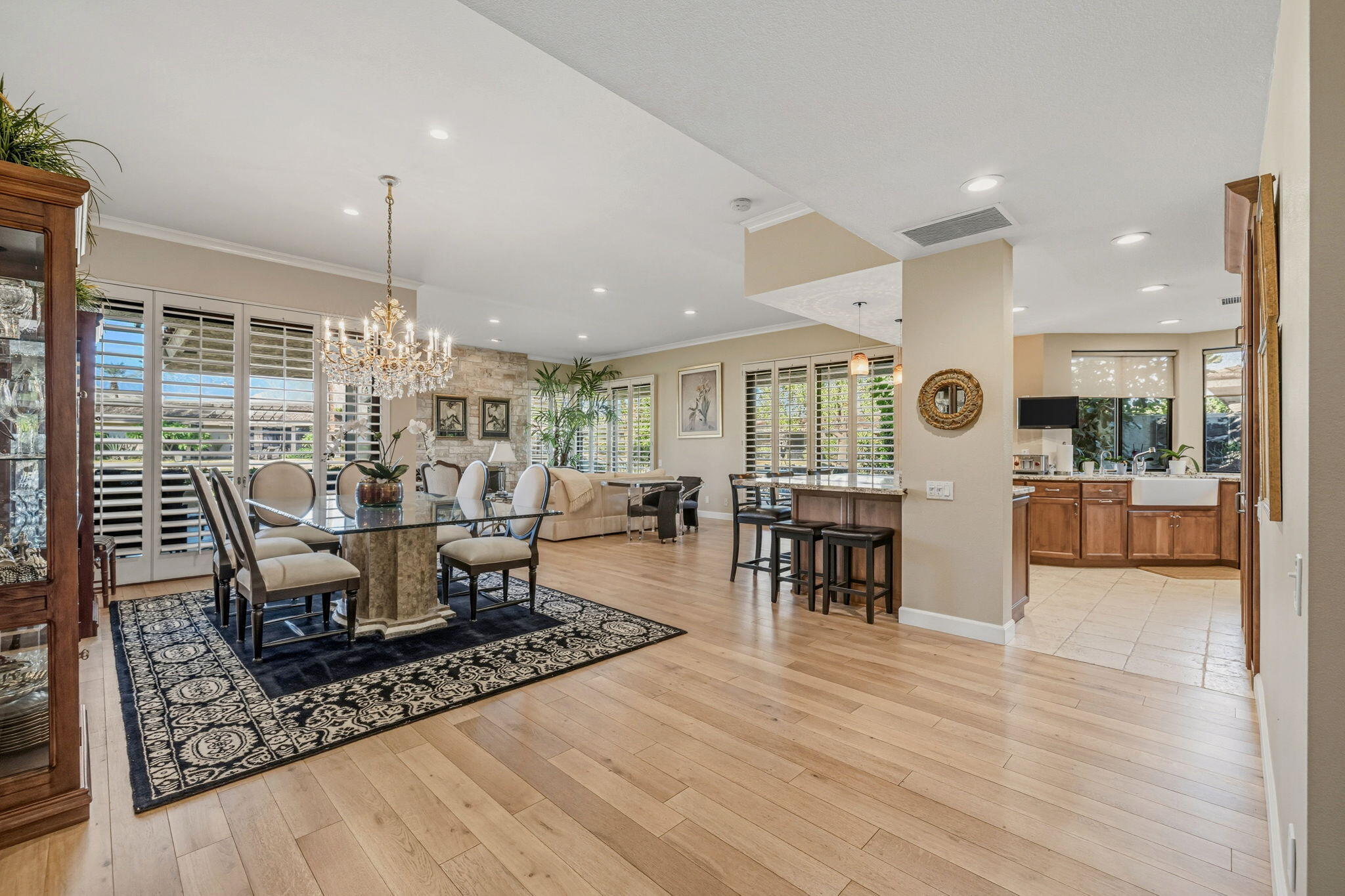 10 Whittier Court Rancho Mirage, CA 92270 - Photo 8 of 62 a living room with furniture a wooden floor and kitchen view