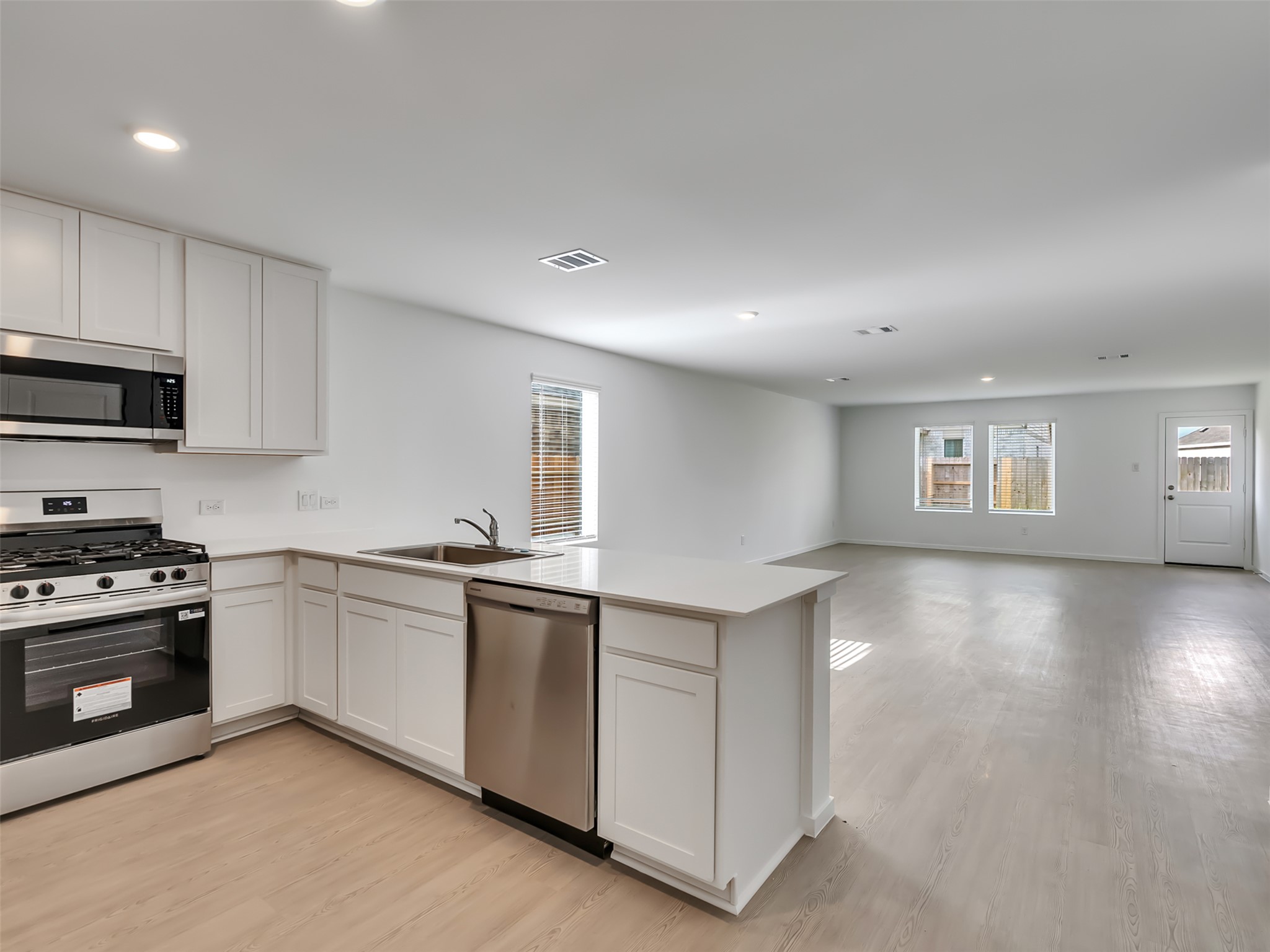 3041 Colusa Rdg Drive Katy, TX 77493 - Photo 6 of 26 a kitchen with a stove and white cabinets