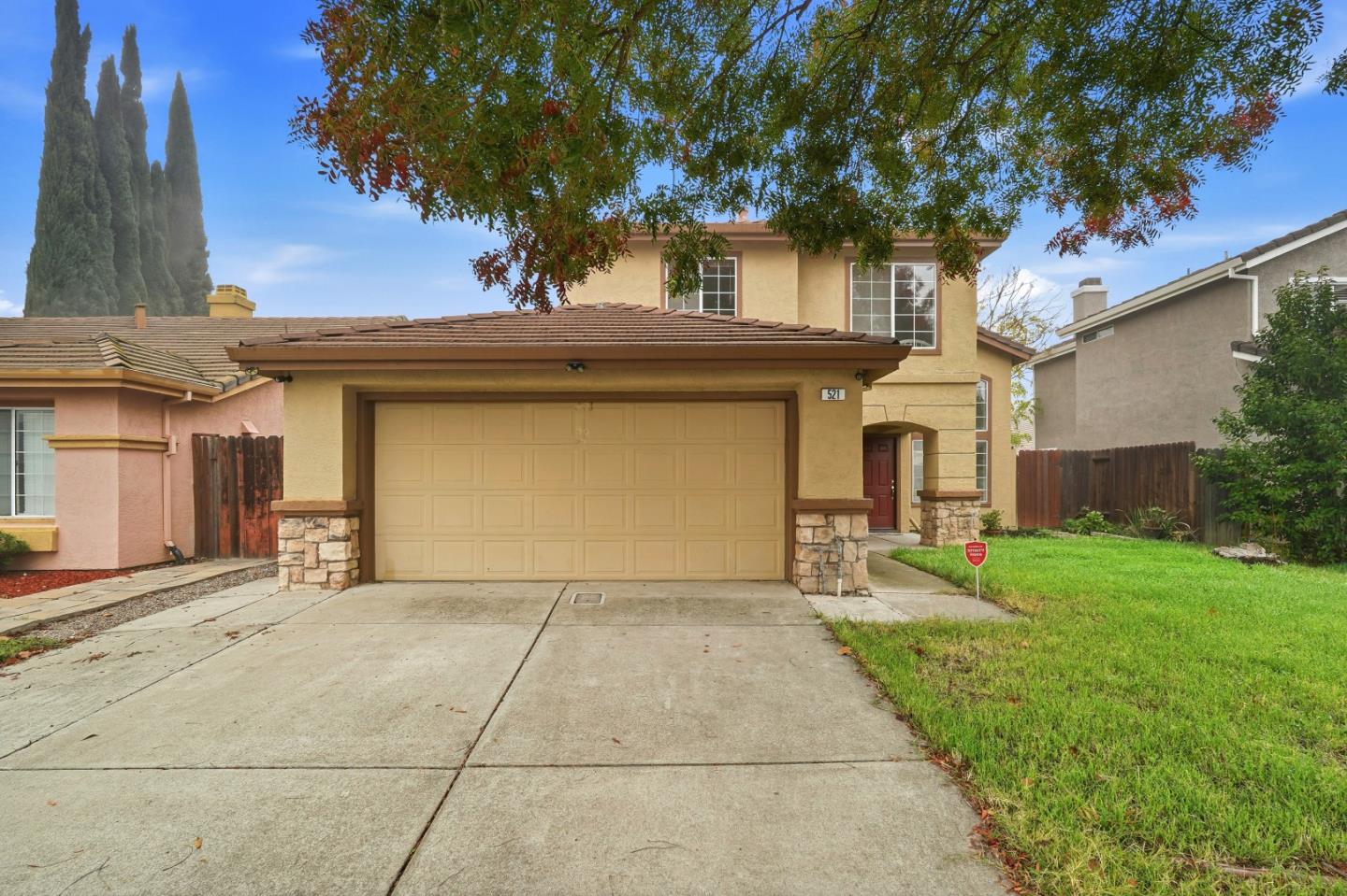 a front view of a house with a yard and garage