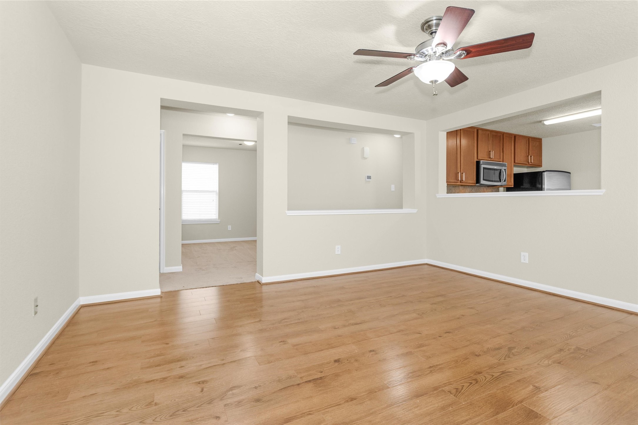 3131 Beacon Grove Street Spring, TX 77389 - Photo 9 of 38 a view of an empty room with window and wooden floor