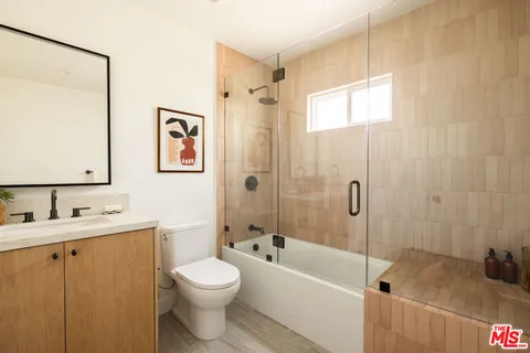 a bathroom with a toilet a sink and bathtub
