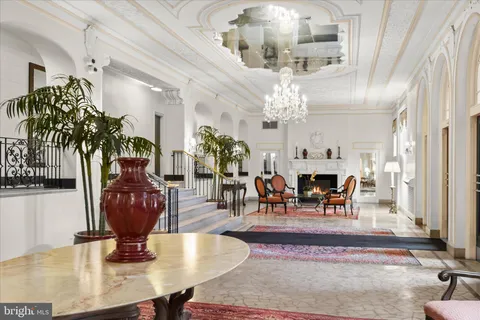 a lobby with furniture and a chandelier