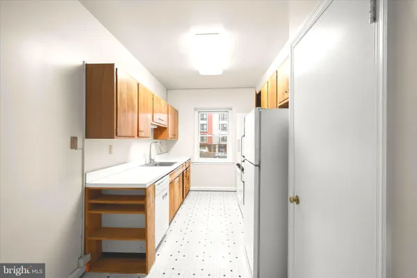 a kitchen with a sink and a refrigerator