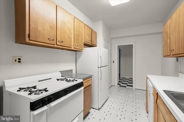 a kitchen with stainless steel appliances a stove a sink and a refrigerator