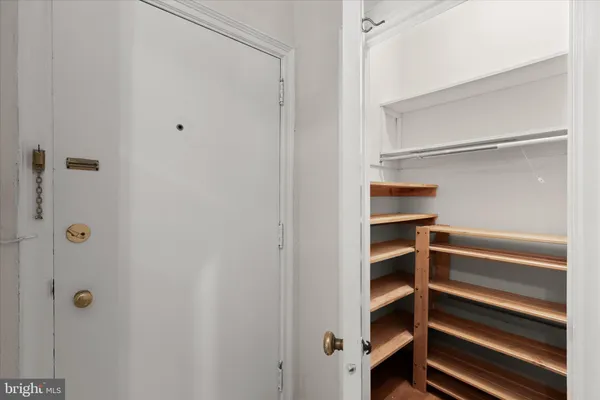 a view of walk in closet with empty racks
