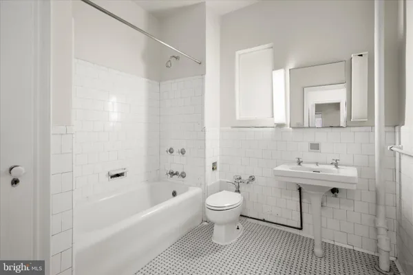 a bathroom with a sink toilet a shower and bathtub