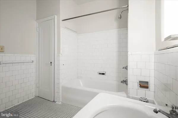 a bathroom with a bathtub and a shower