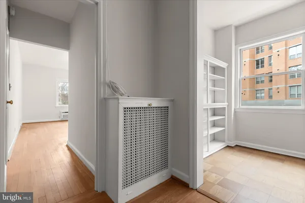 a view of a room with wooden floor and windows