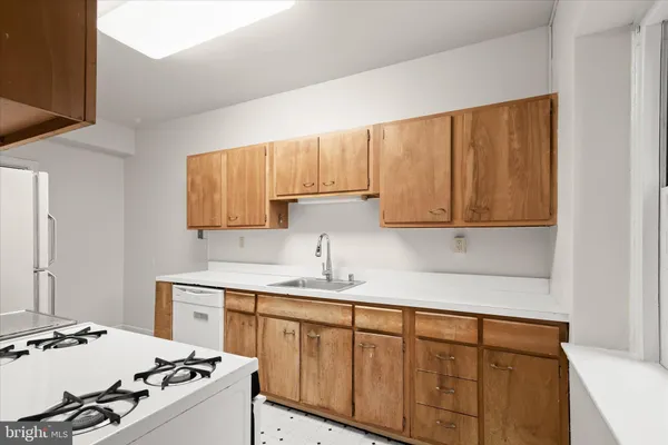 a kitchen with a sink stove and cabinets