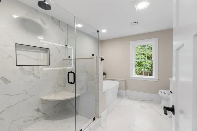 a bathroom with a toilet and shower
