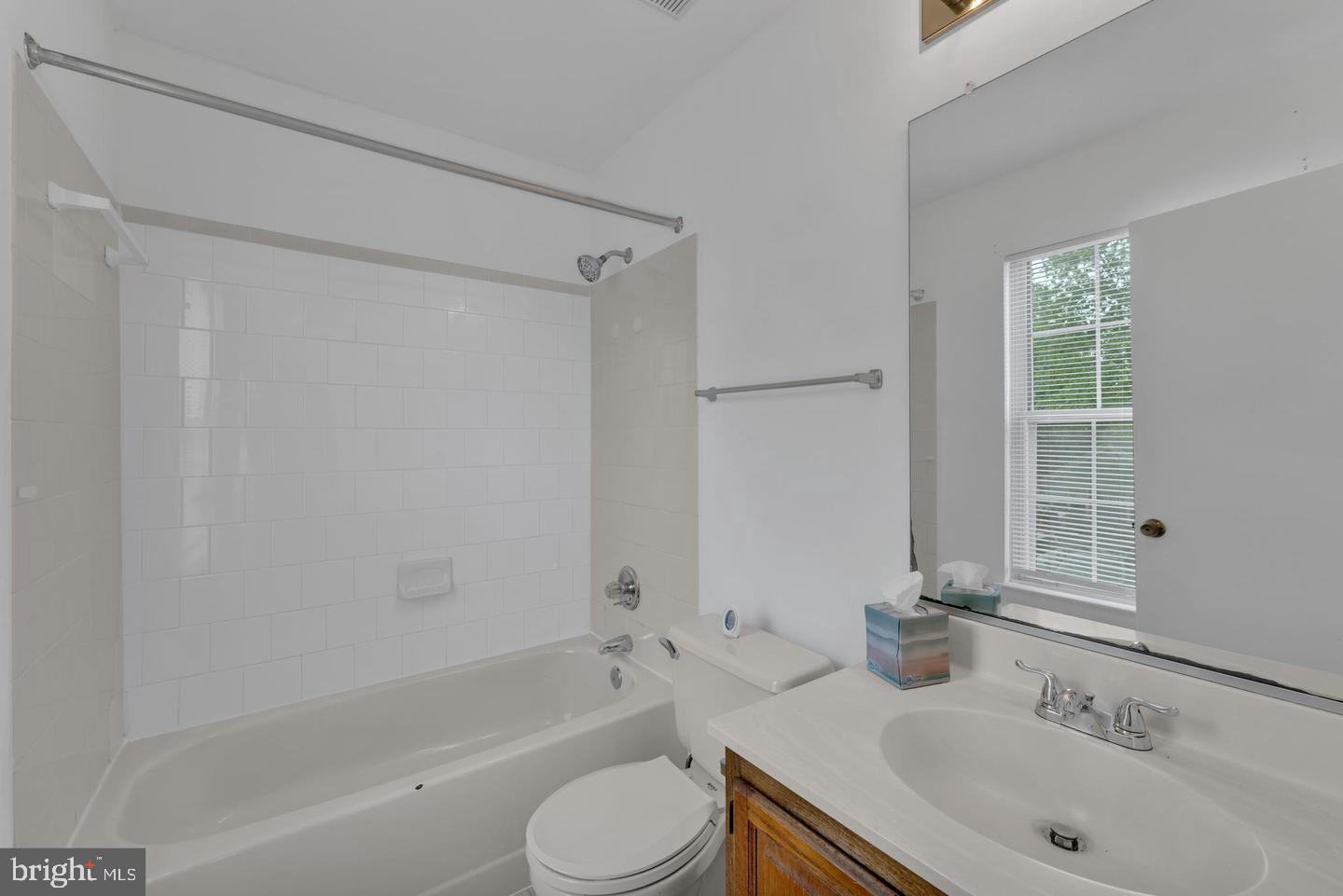 14314 Colonel Clagett Court, Unit 319 Upper Marlboro, MD 20772 - Photo 12 of 15 a bathroom with a sink toilet and shower