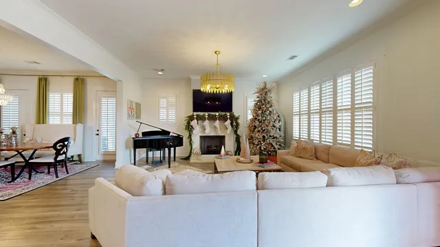 a living room with fireplace furniture and a large window