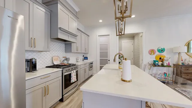 a kitchen with stainless steel appliances granite countertop a sink dishwasher and cabinets with wooden floor