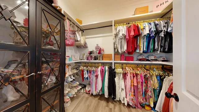 a view of walk in closet with clothes